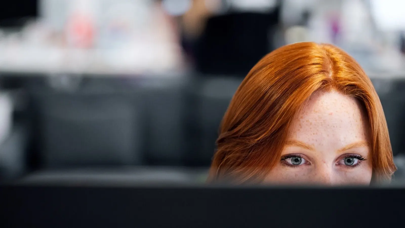 Software engineer concentrating at a workstation in a modern office