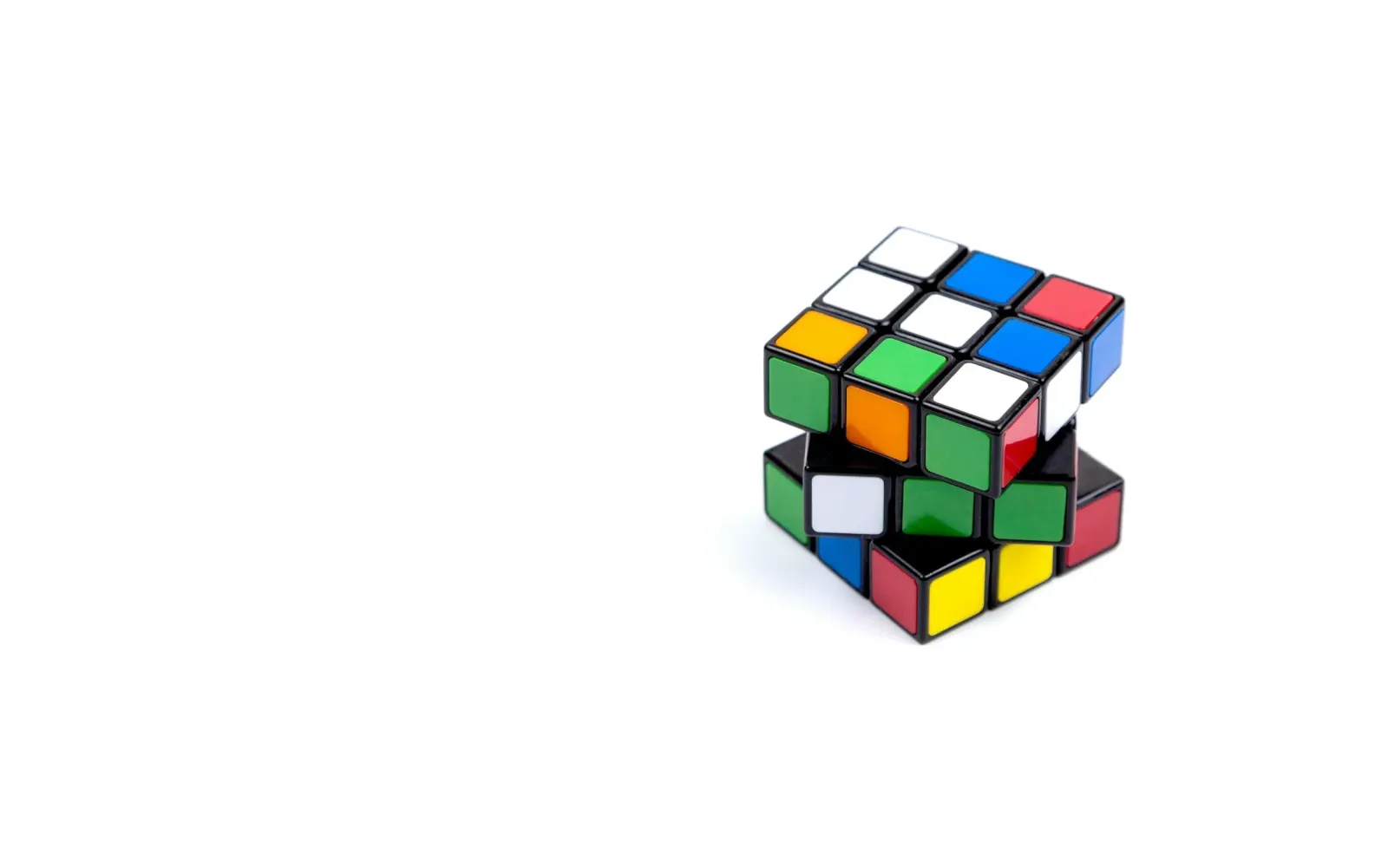Partially solved puzzle cube on a plain white background